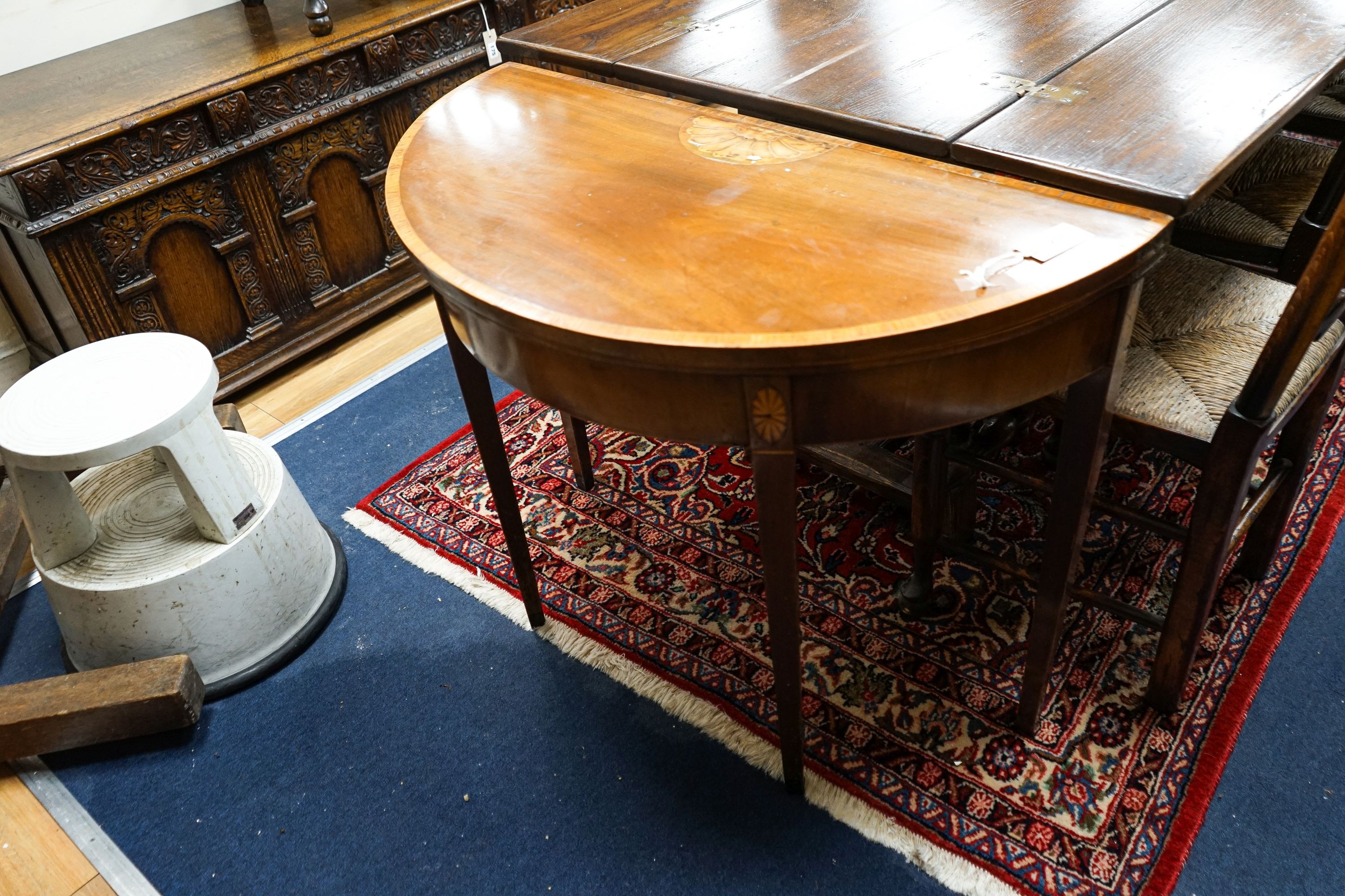 A George III inlaid and cross banded mahogany demi-lune card table with folding top, width 91cm, depth 44cm, height 72cm